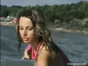 Молодая модель показывает красивую грудь на море